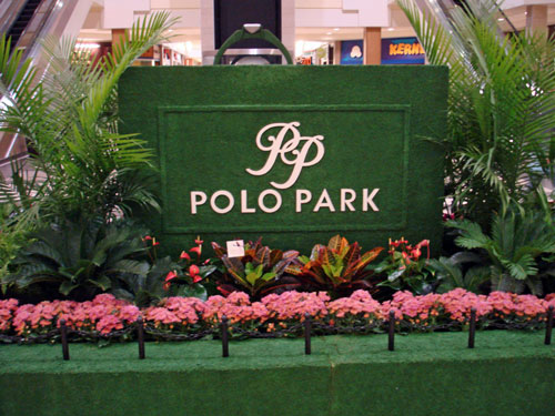 Polo Park Logo on a moss background in front of flowers